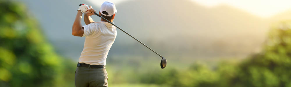 Man swinging the golf club on the golf course Man swinging the golf club on the golf course